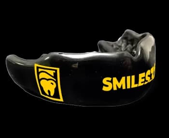 Custom-fit GumGear mouthguard on a dark backdrop